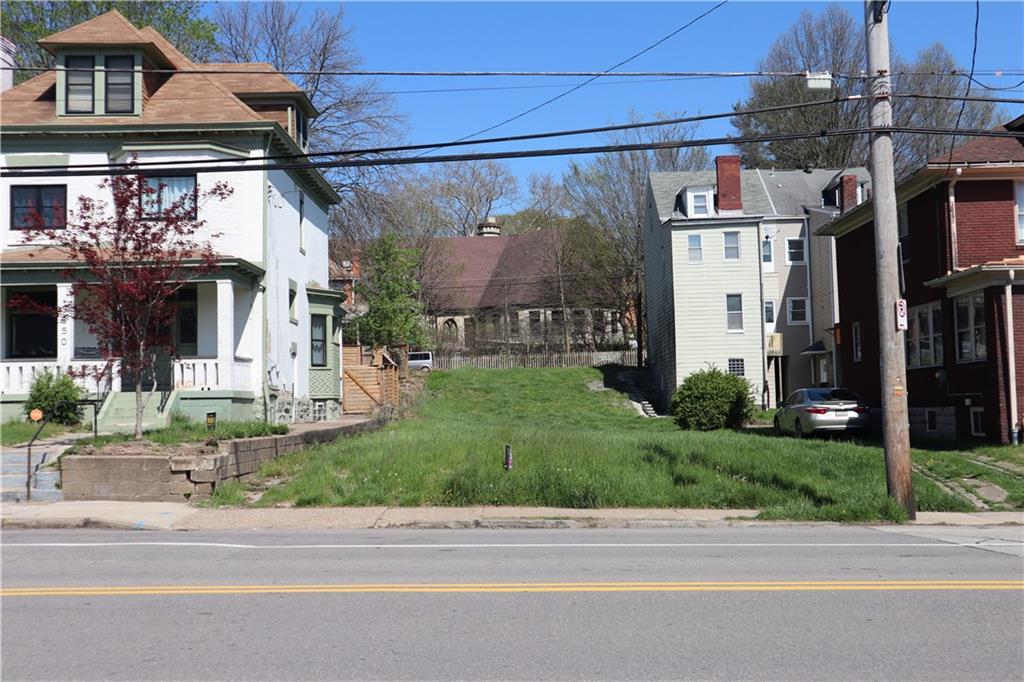 a view of a building with a yard