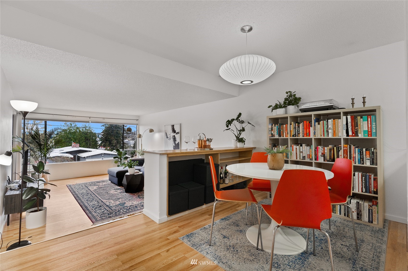 a view of a workspace with furniture and a book shelf