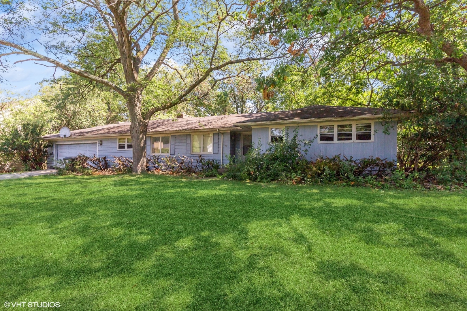 a front view of house with yard and green space