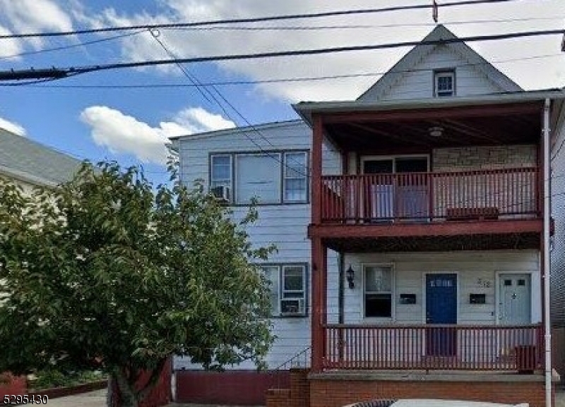 a view of a house with potted plants