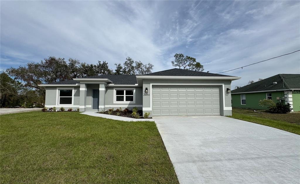 a front view of a house with a yard and garage