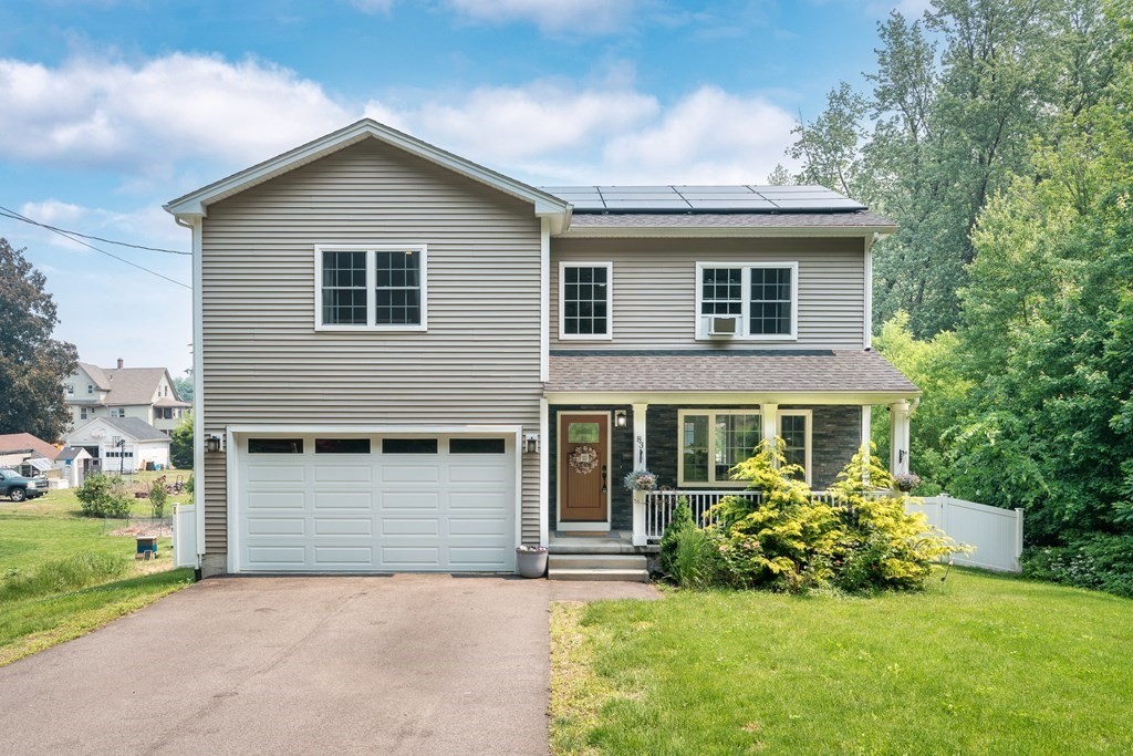 a front view of a house with a yard and garage