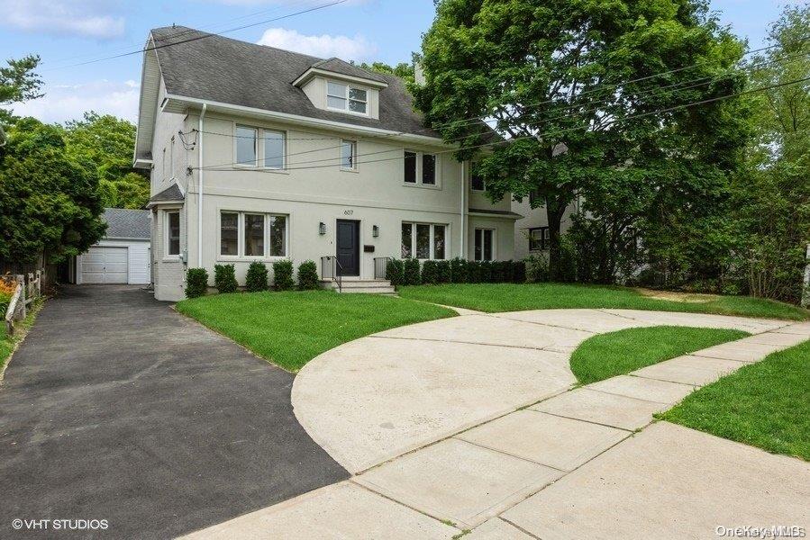 a view of white house with a yard