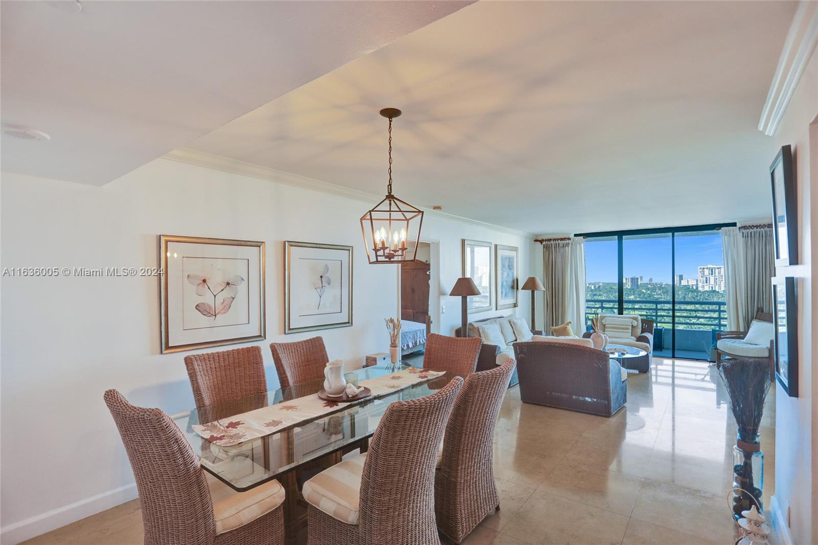 a dining room with furniture a chandelier and window