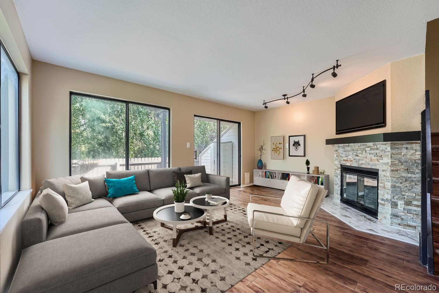 a living room with furniture a fireplace and a flat screen tv