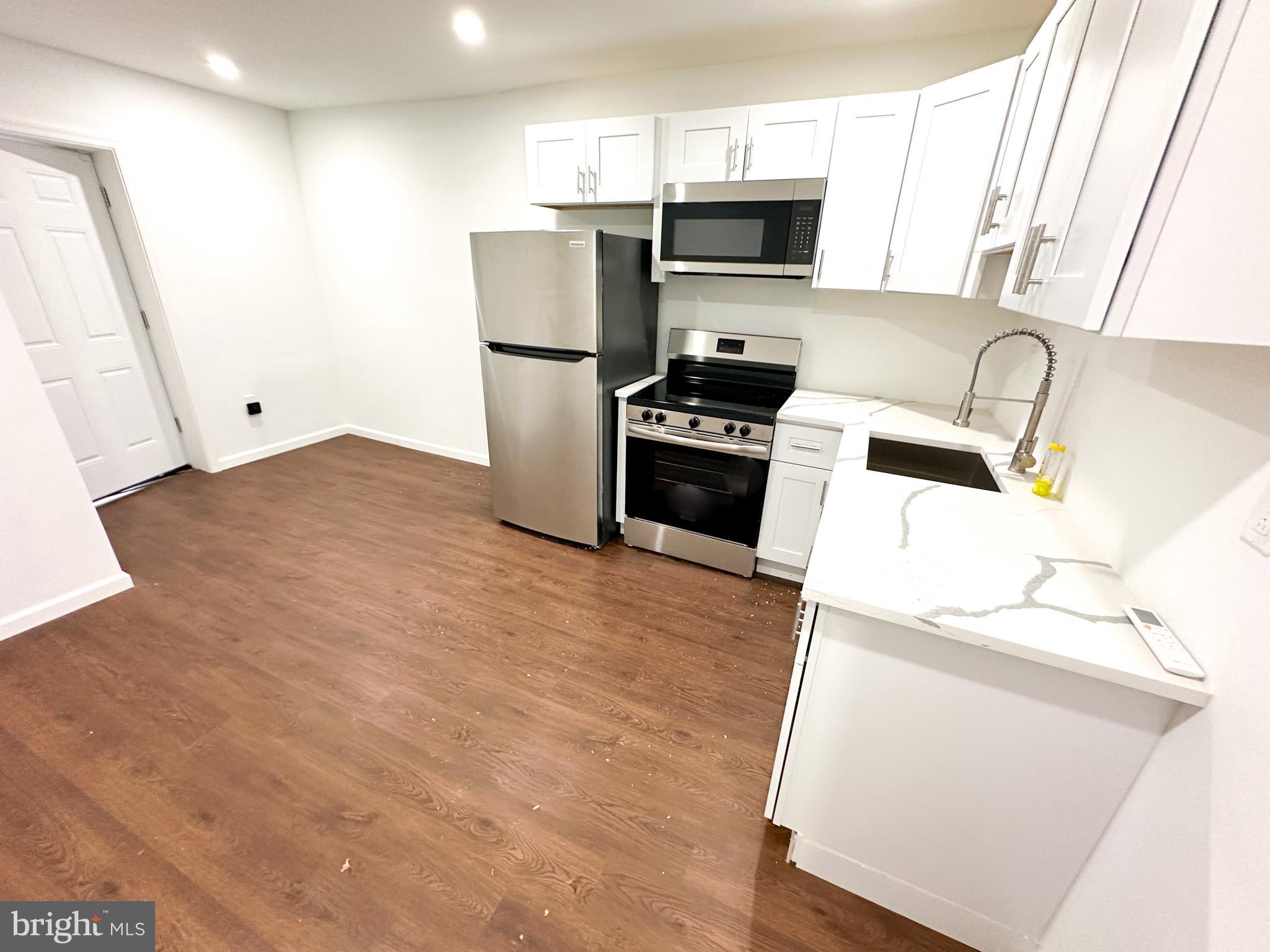 a kitchen with stainless steel appliances a refrigerator stove and sink