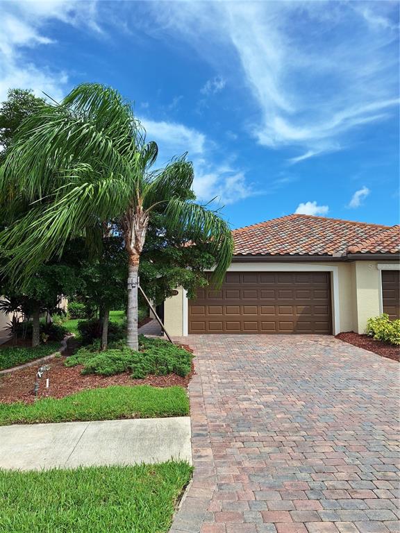 a front view of a house with a yard and a garage