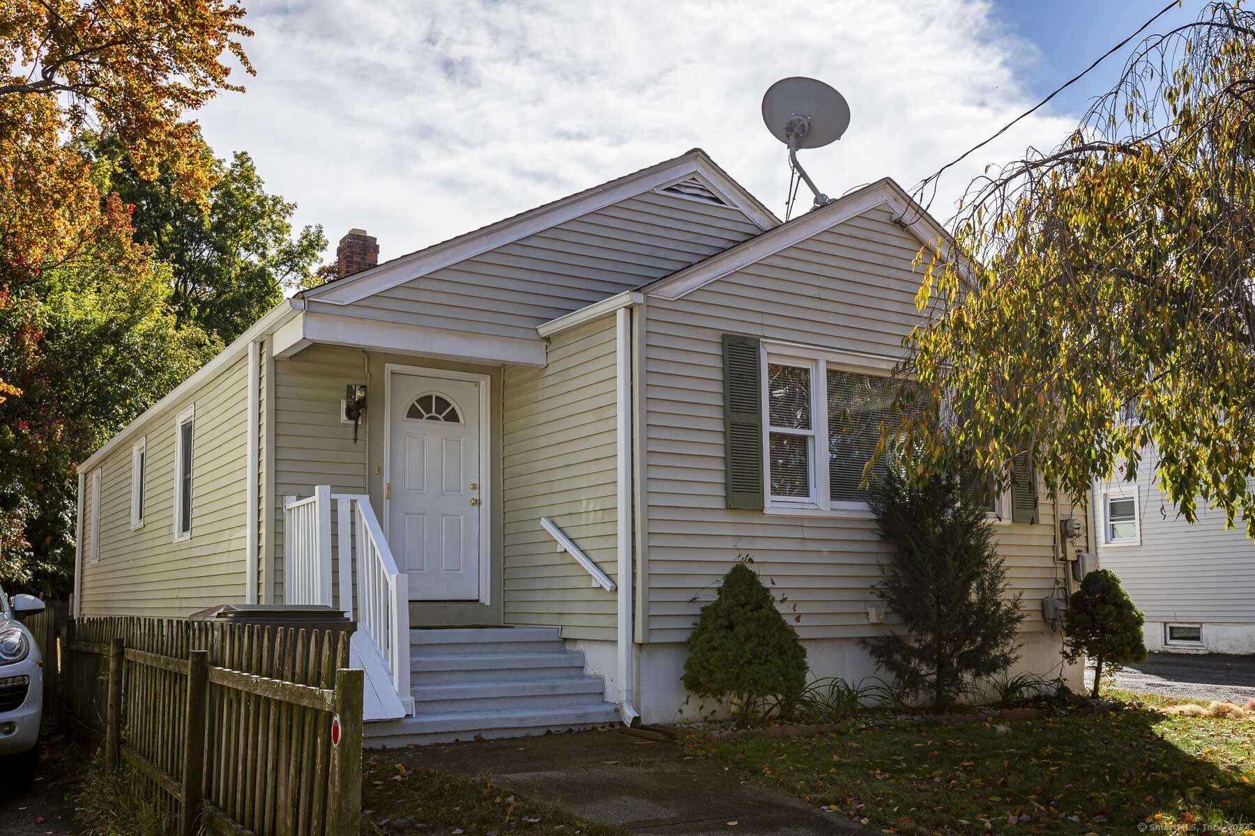 a view of a house with wooden fence