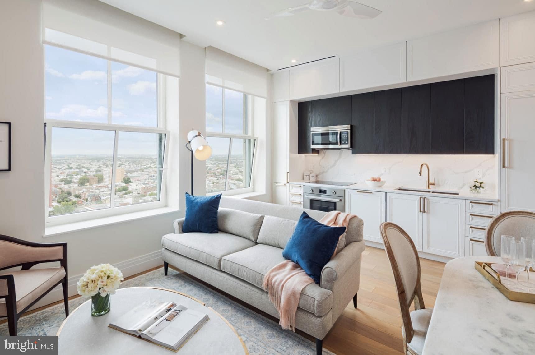 a living room with furniture a flat screen tv and a large window