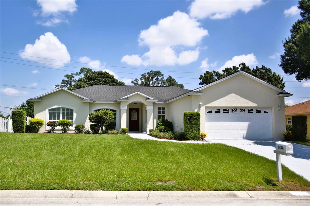 a front view of house with yard and green space