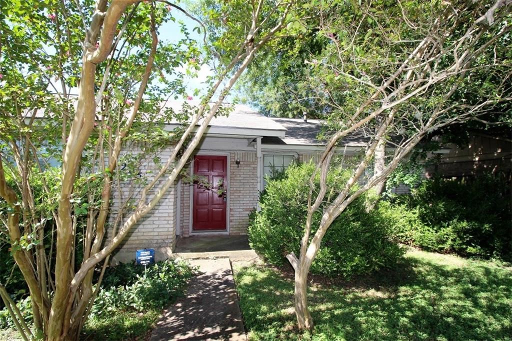 front view of a house with a tree