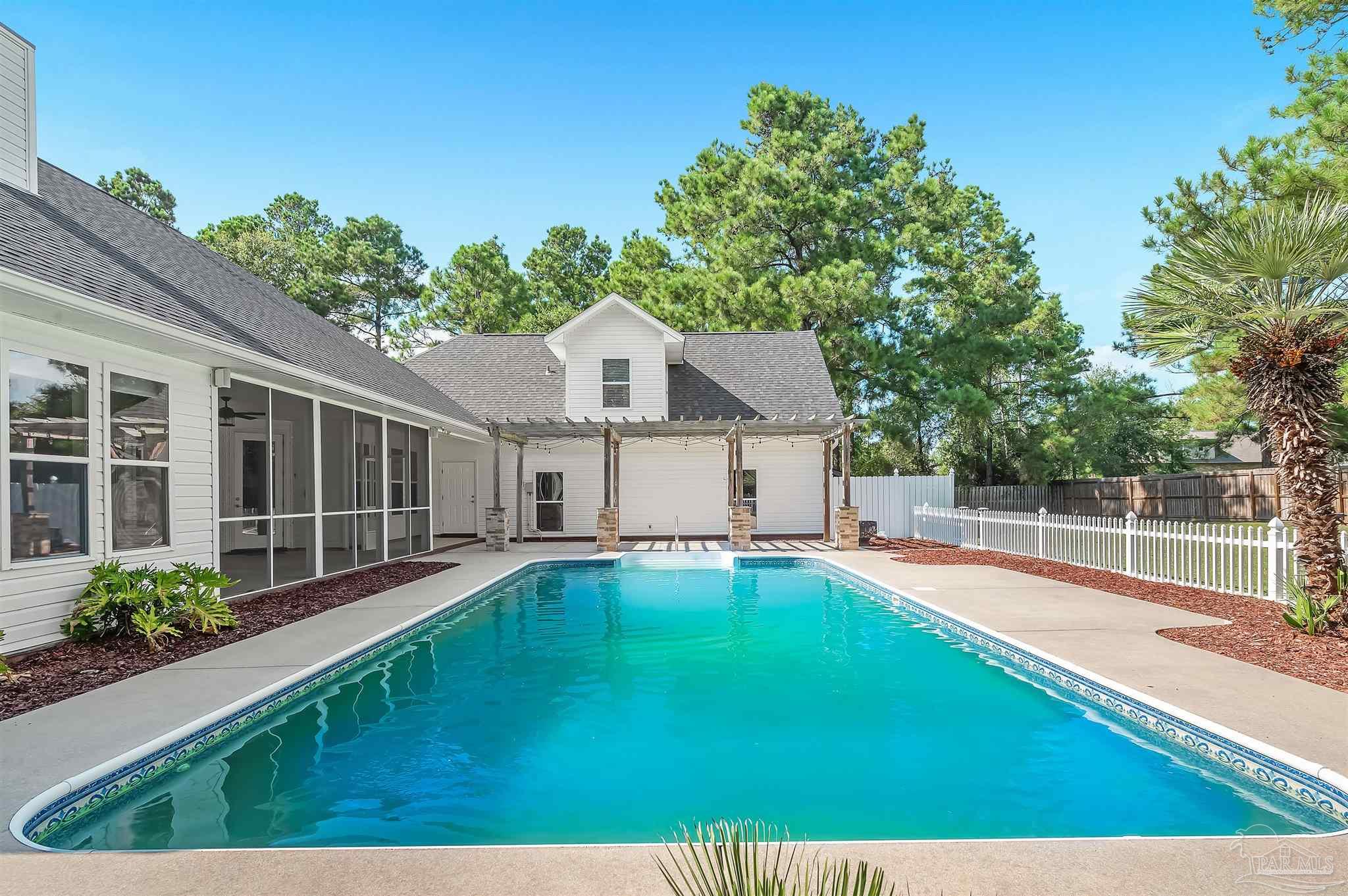 a swimming pool with outdoor seating and yard