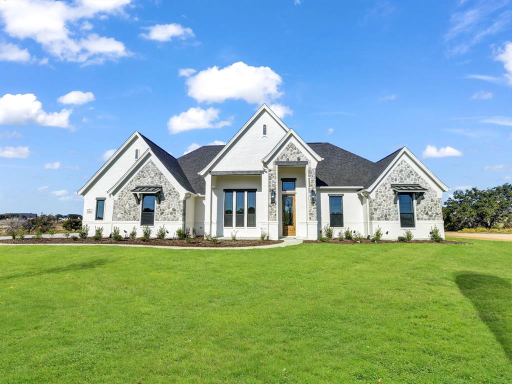 a front view of a house with a yard