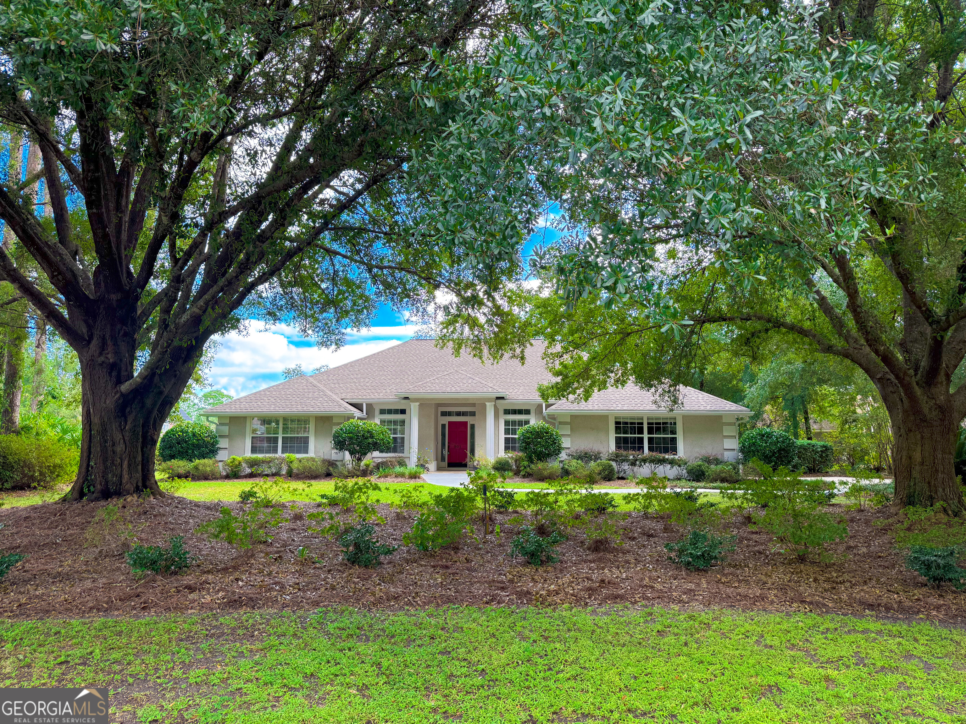 a front view of house with yard and green space