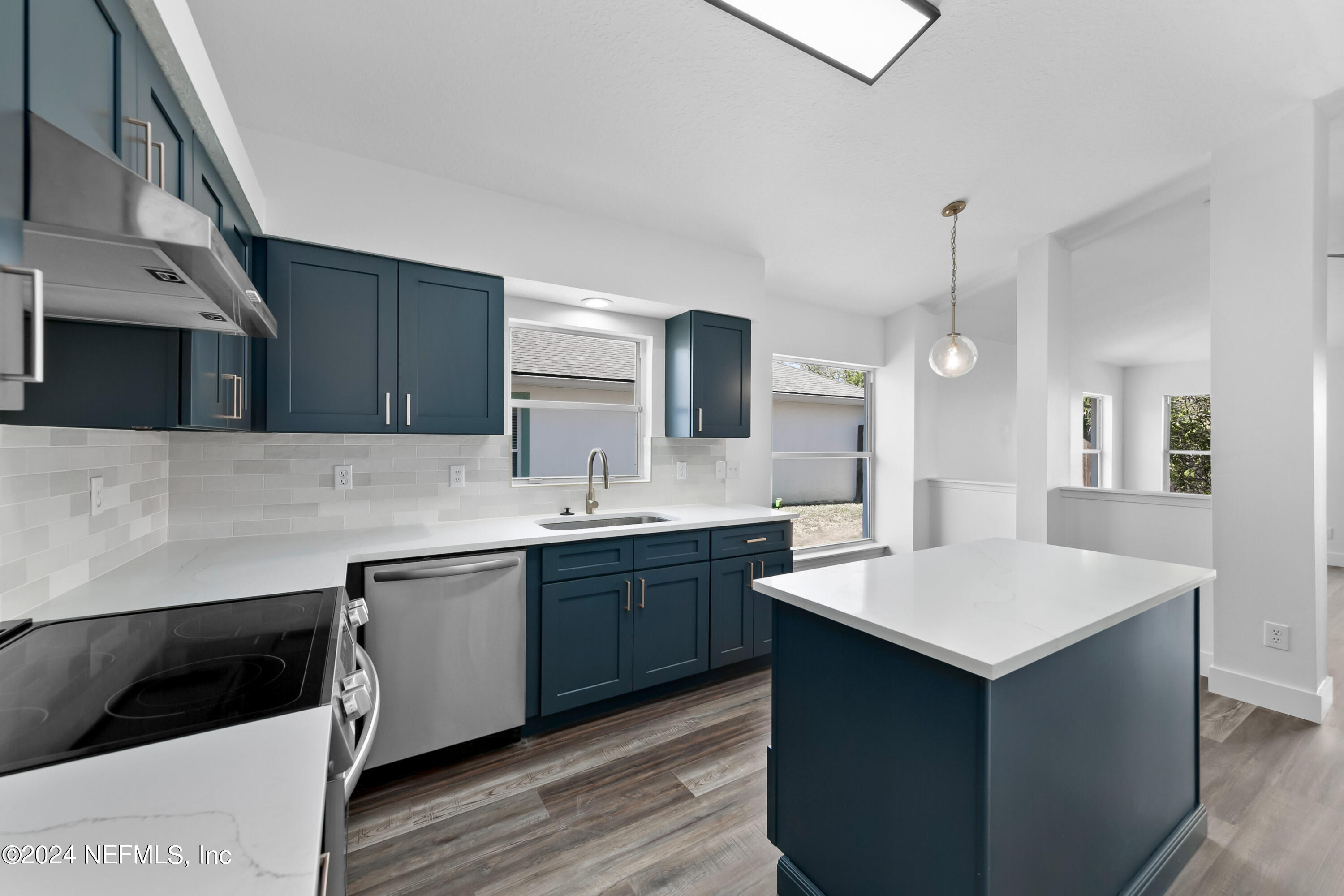 a kitchen with a sink and cabinets