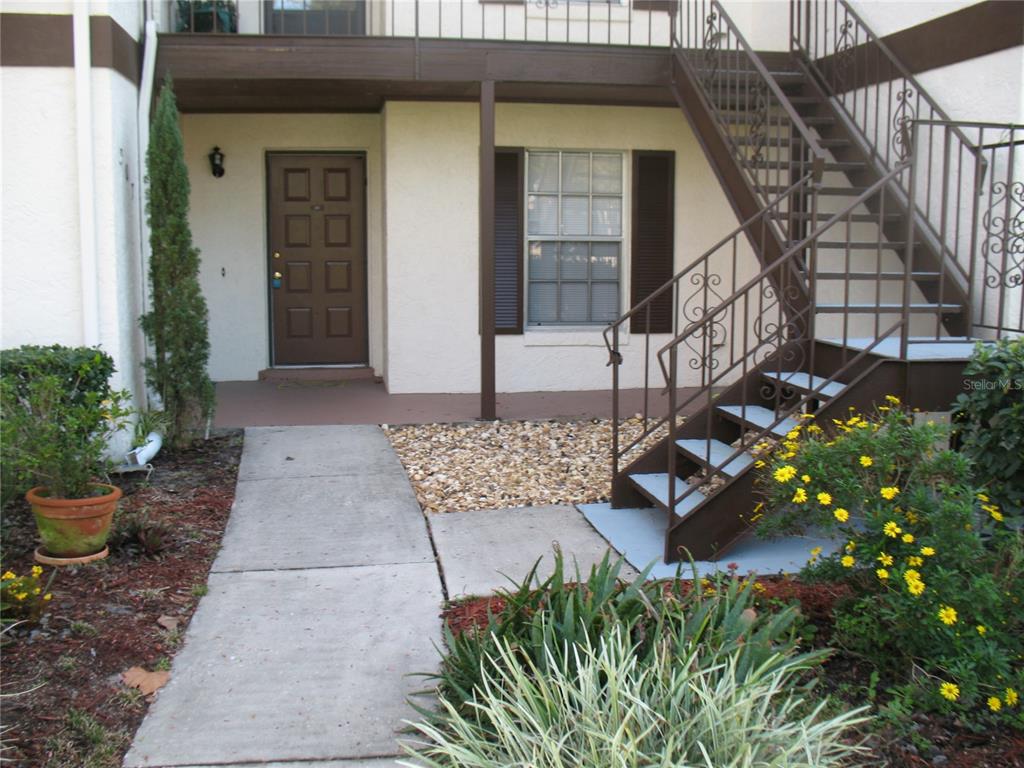 a view of a house with backyard and sitting area