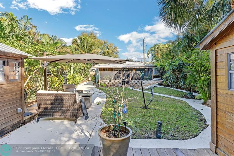 a view of a chairs and table in backyard