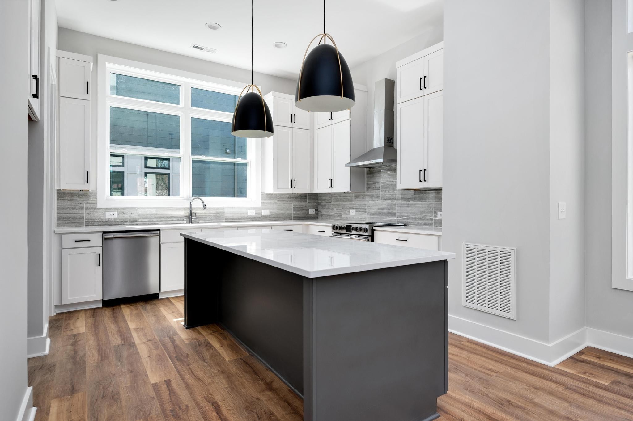 a kitchen with a sink cabinets and window