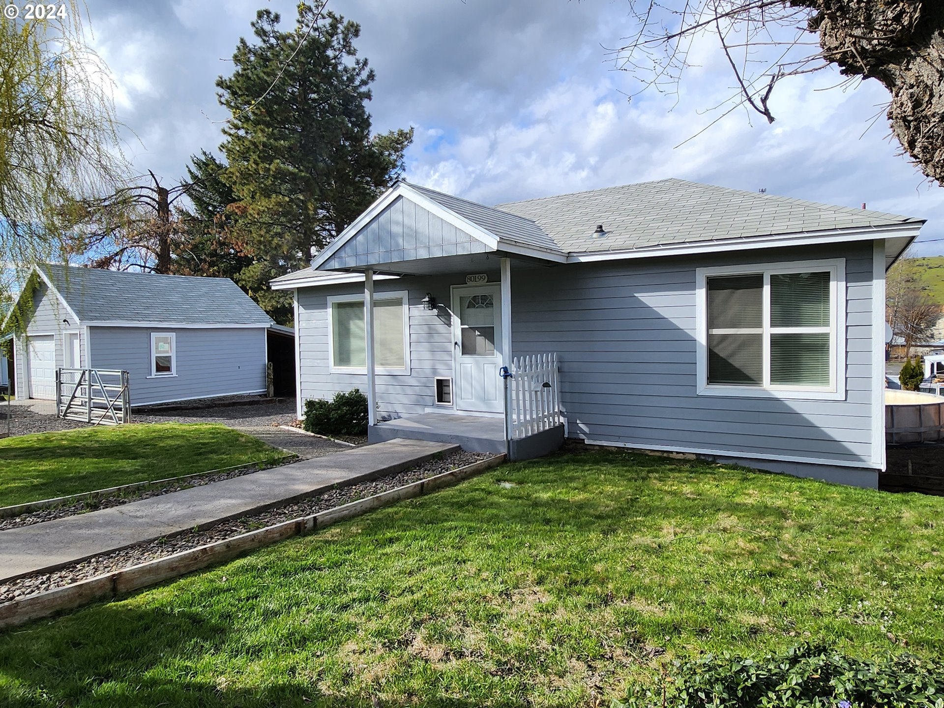 a front view of a house with a yard and porch