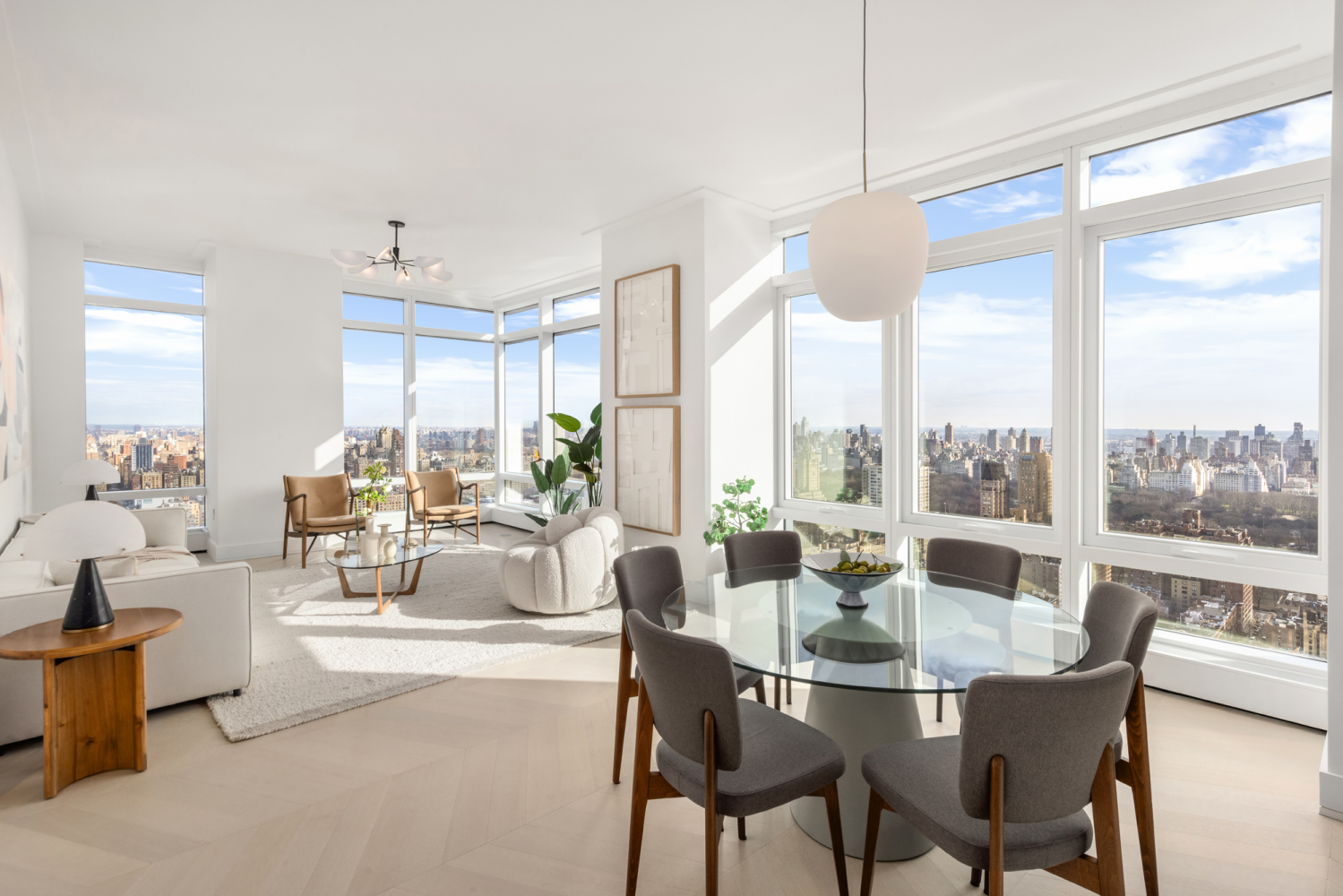 a dining room with furniture a chandelier and wooden floor