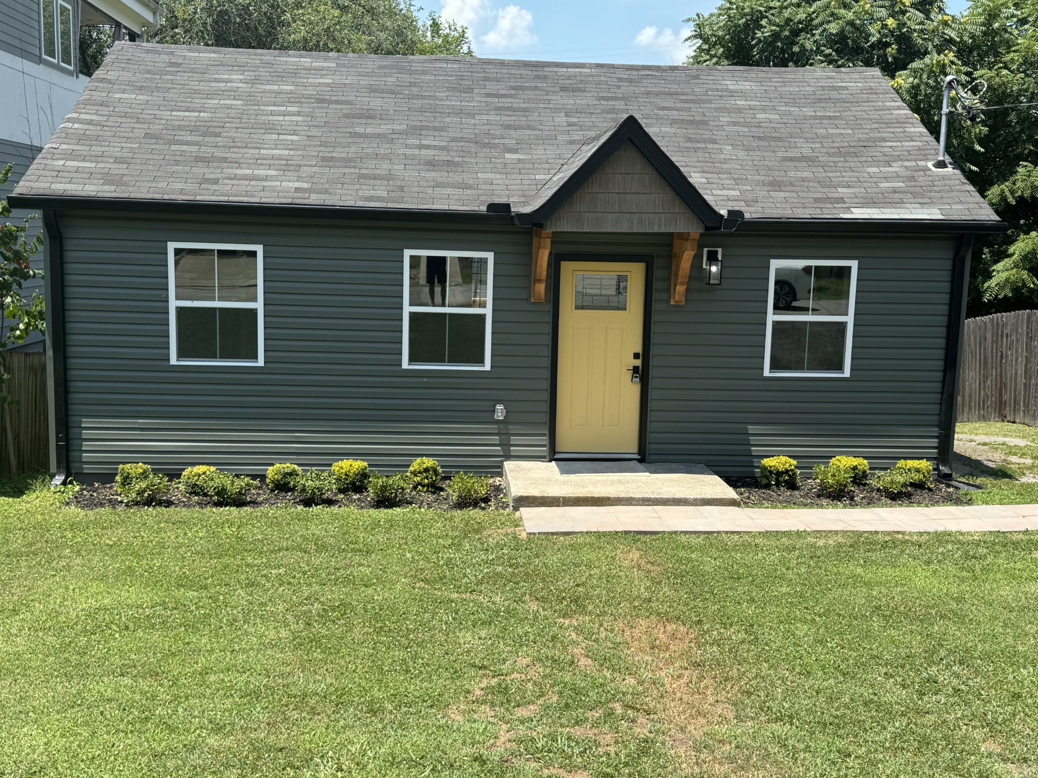 a front view of house with a garden