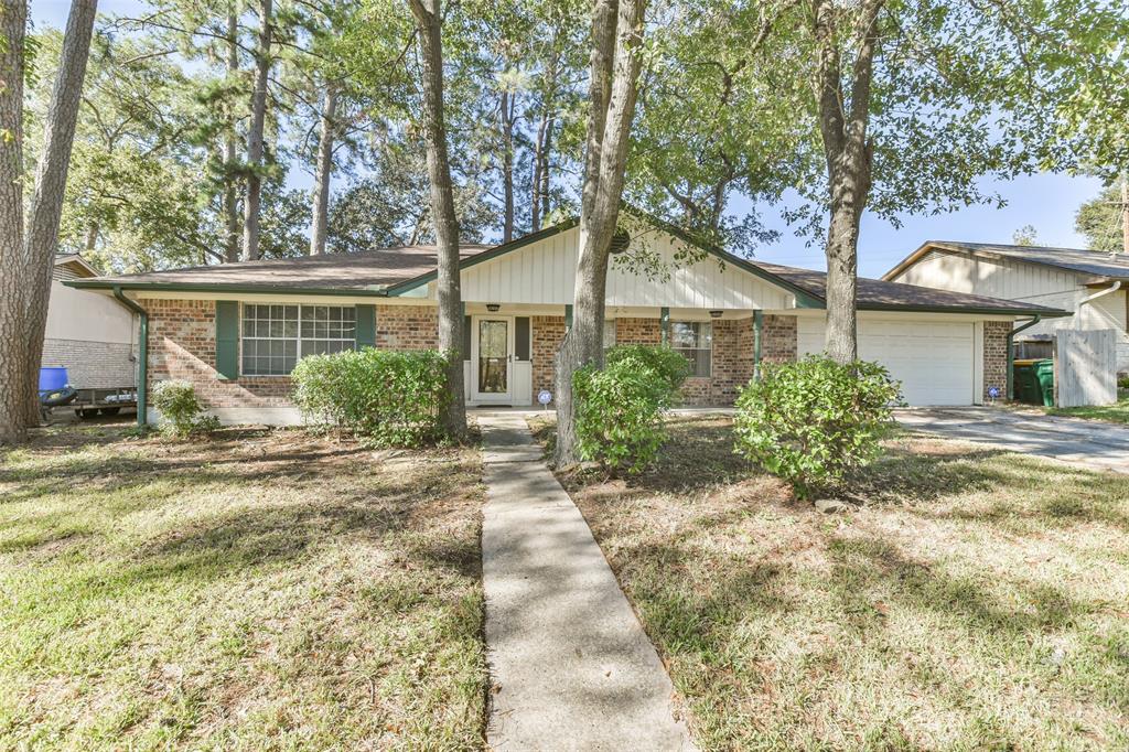 Charming brick home with great curb appeal, nestled among mature trees and landscaped greenery. A welcoming front walkway leads to the covered entryway, and the attached garage adds convenience. This home offers a warm and inviting exterior with a timeless design.