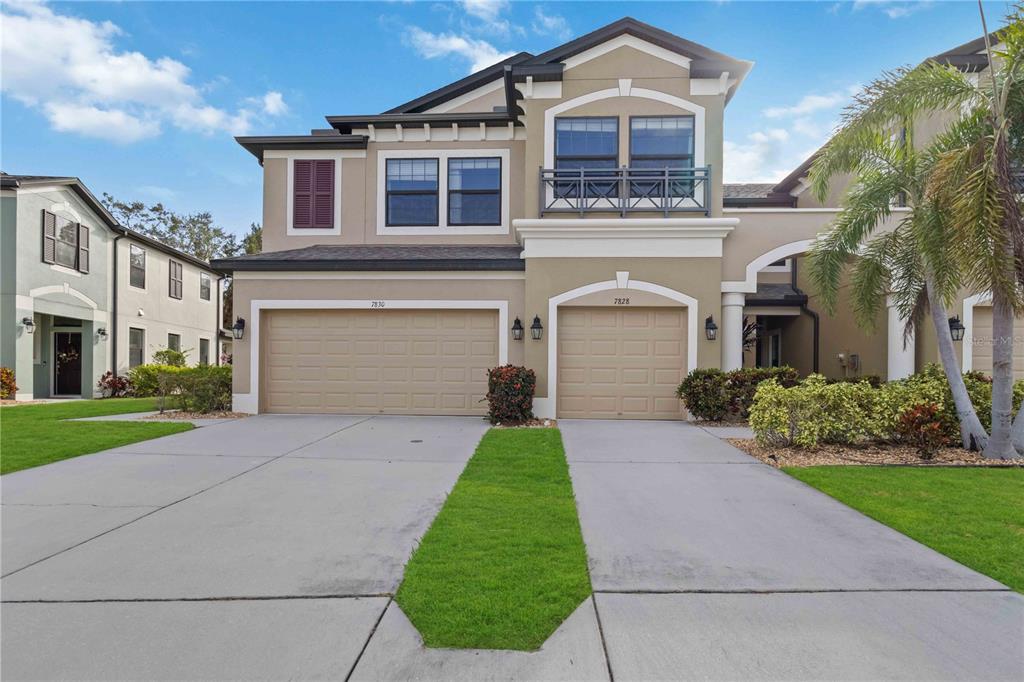 a front view of a house with a yard and garage