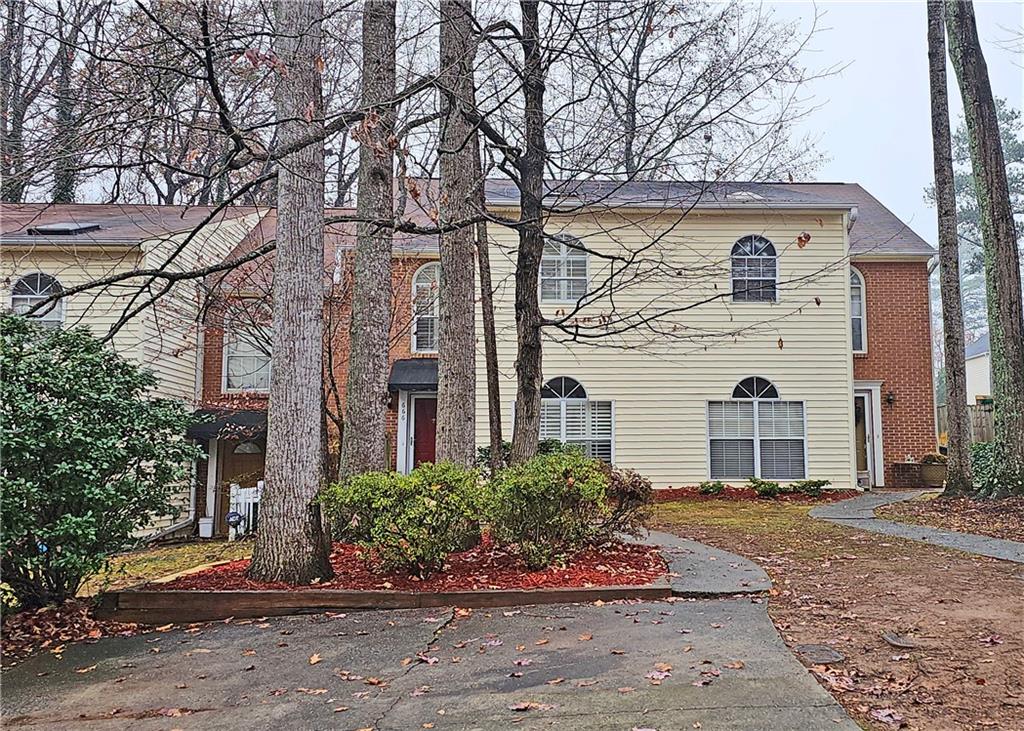 a front view of a house with a garden