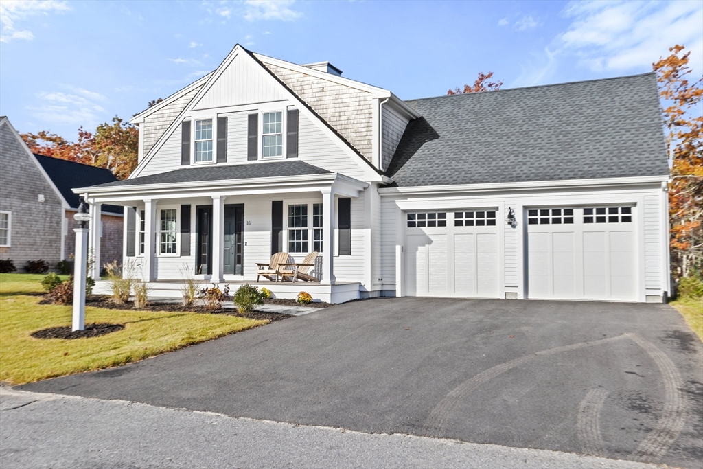 a front view of a house with a yard and a garage