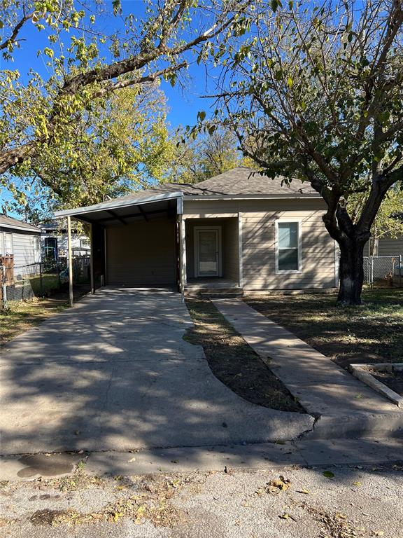 View of front of property featuring a carport