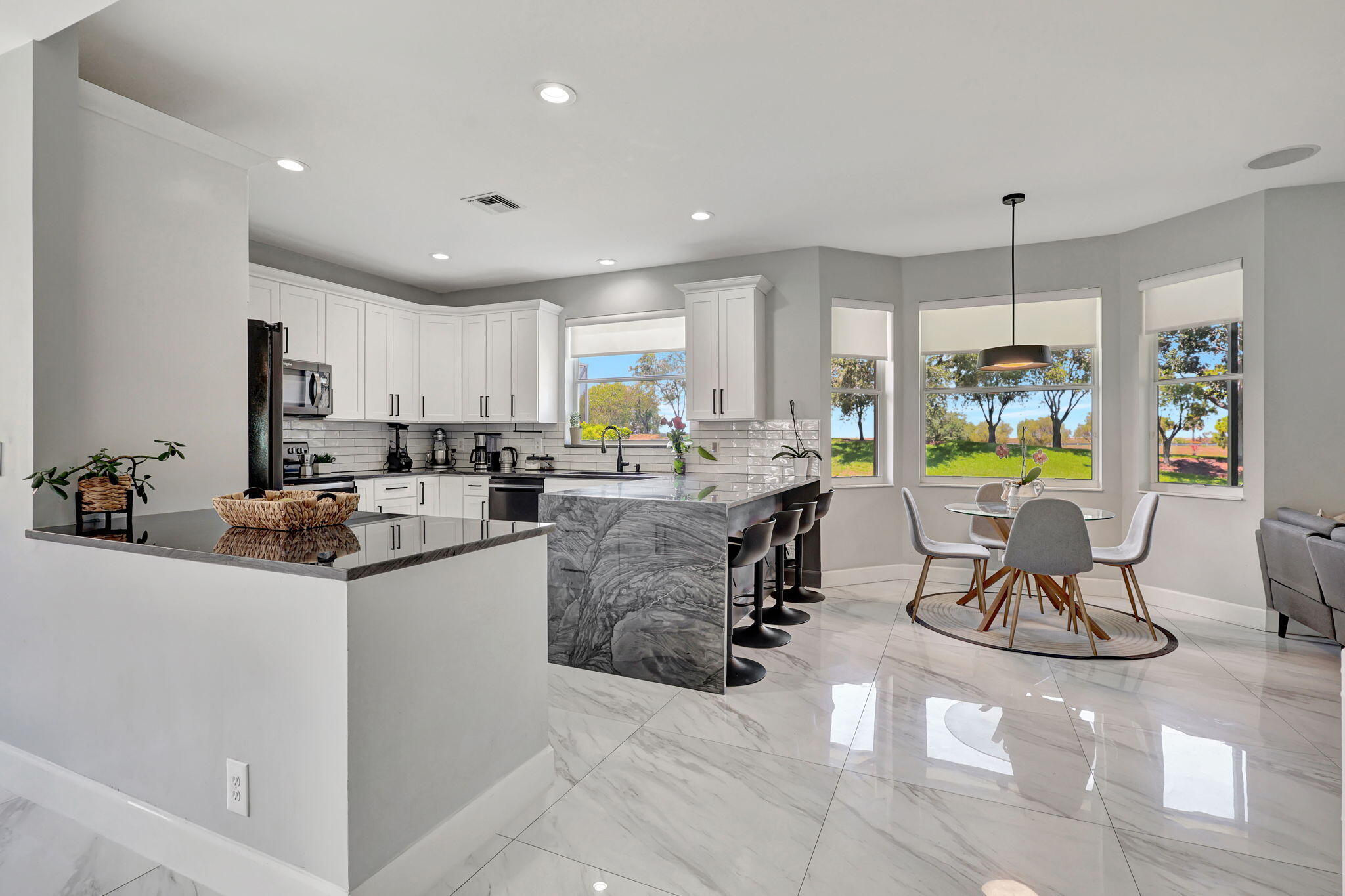 a living room with kitchen island furniture and a chandelier