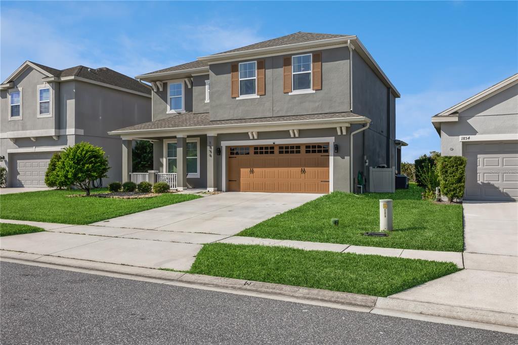 a front view of a house with a yard and garage