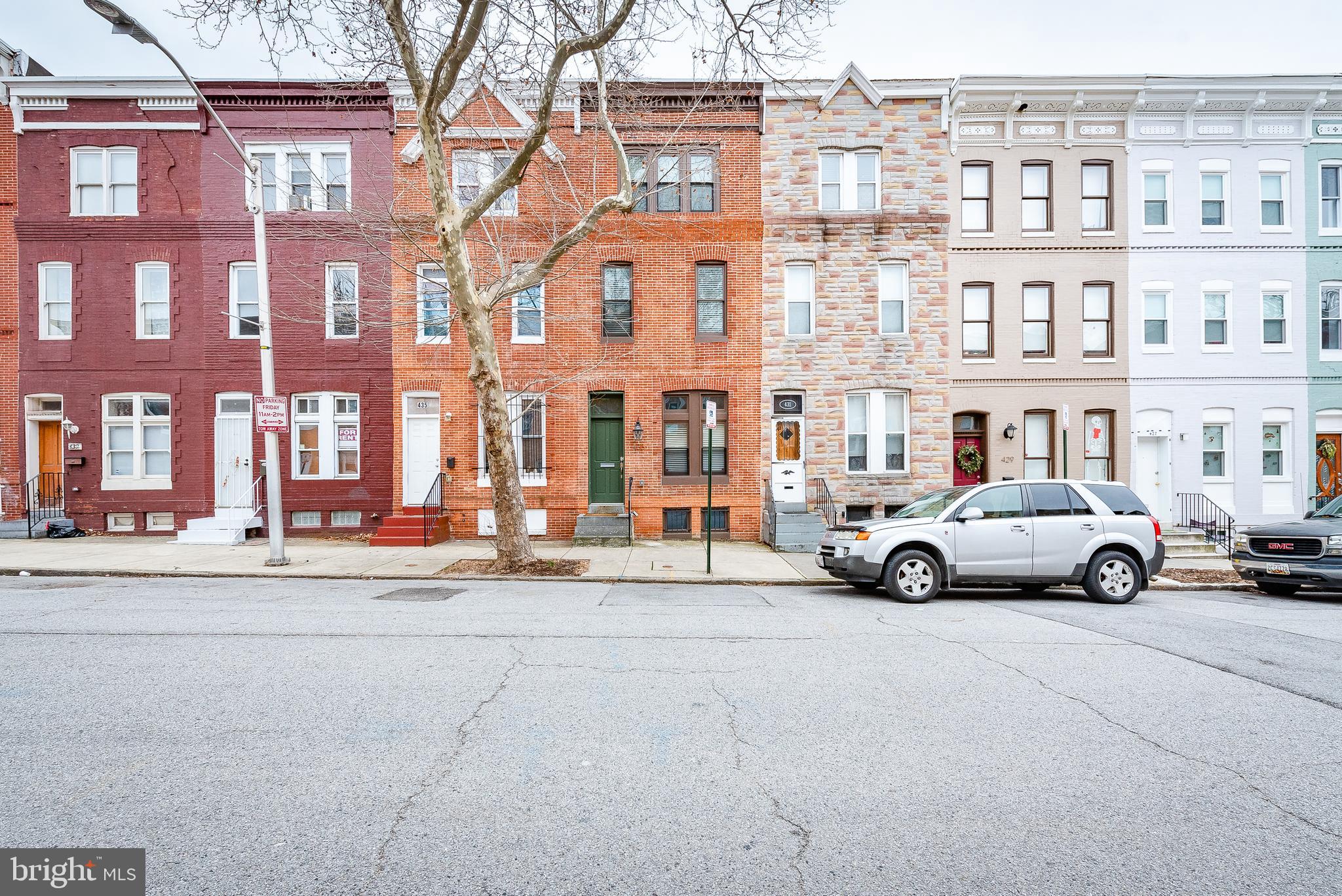 a view of a street that has couple of cars parked on the road