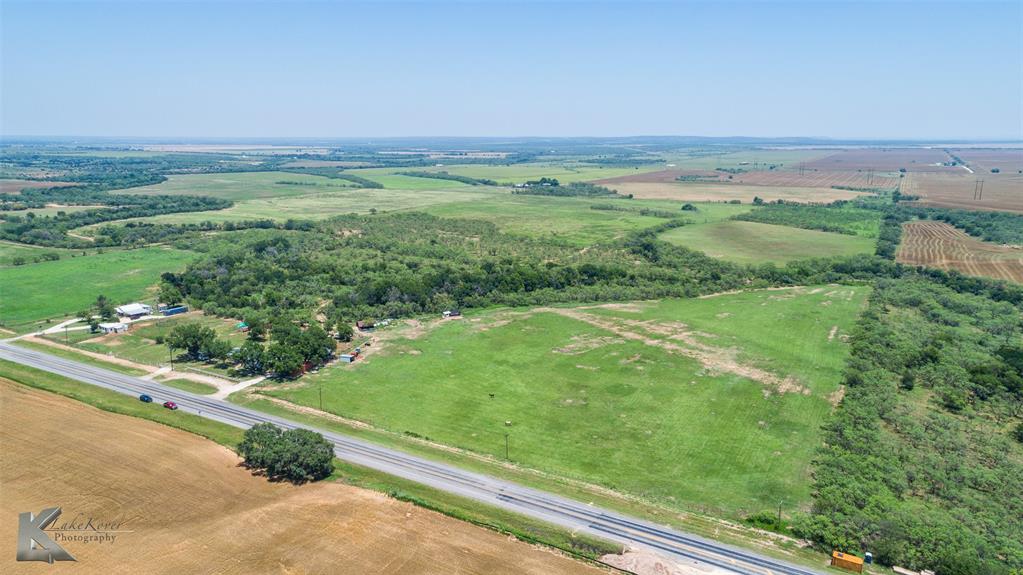 a view of a green field with an ocean view