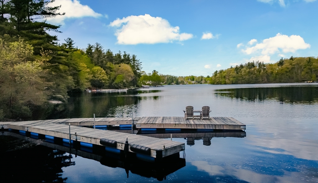 a view of a lake with couches chairs