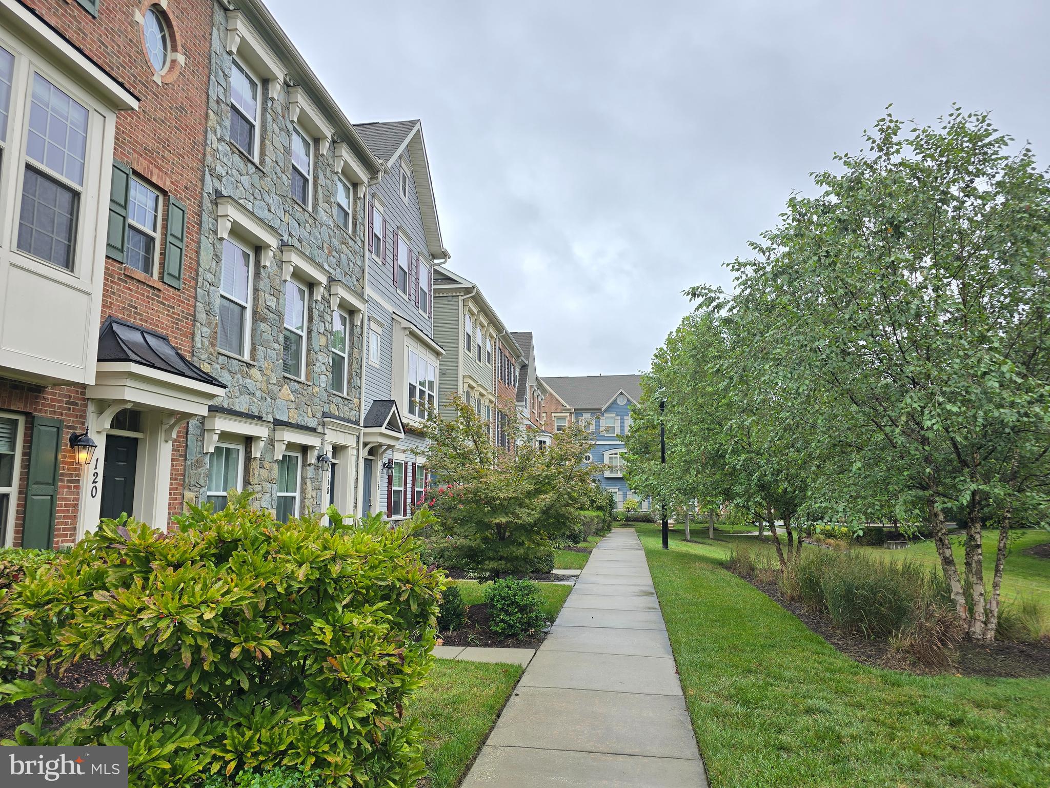 a front view of a residential apartment building with a yard