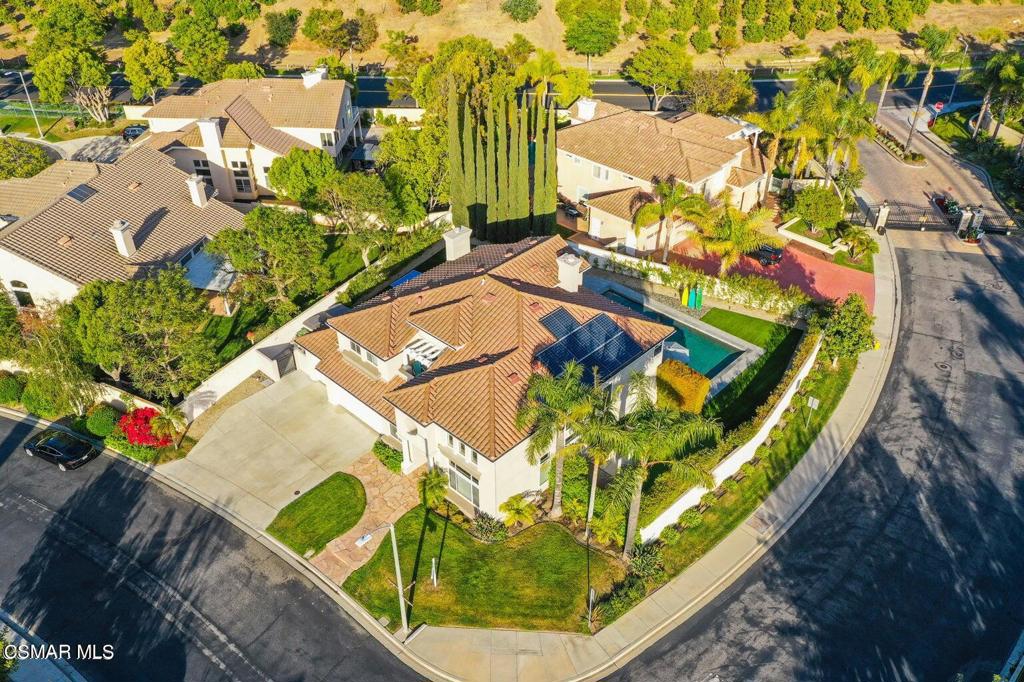 an aerial view of a swimming pool with outdoor seating