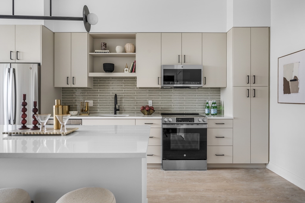 a kitchen with stainless steel appliances a stove sink and refrigerator