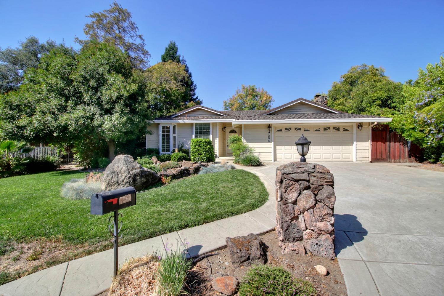 a front view of a house with a yard and outdoor seating