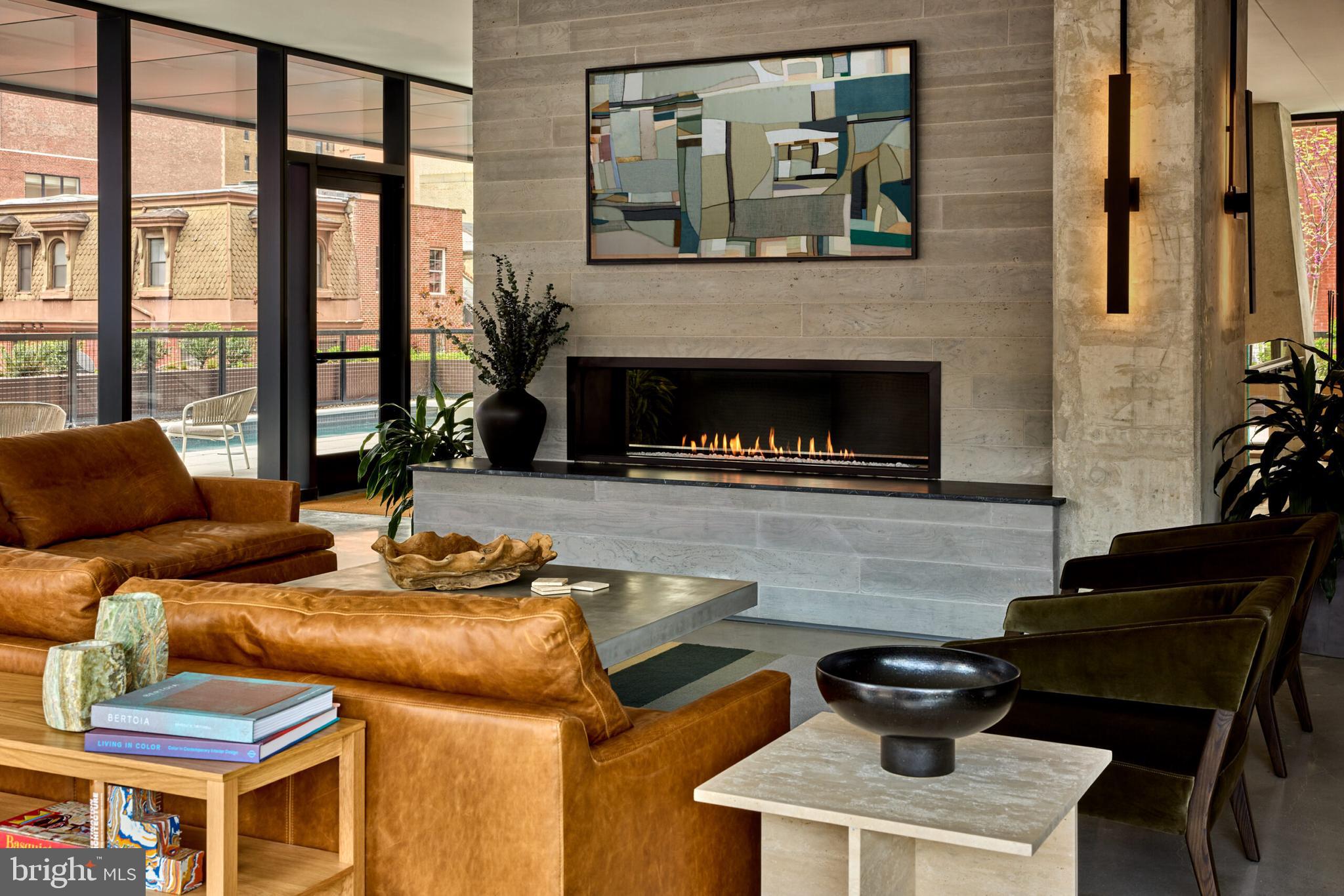 a living room with furniture a fireplace and a potted plant