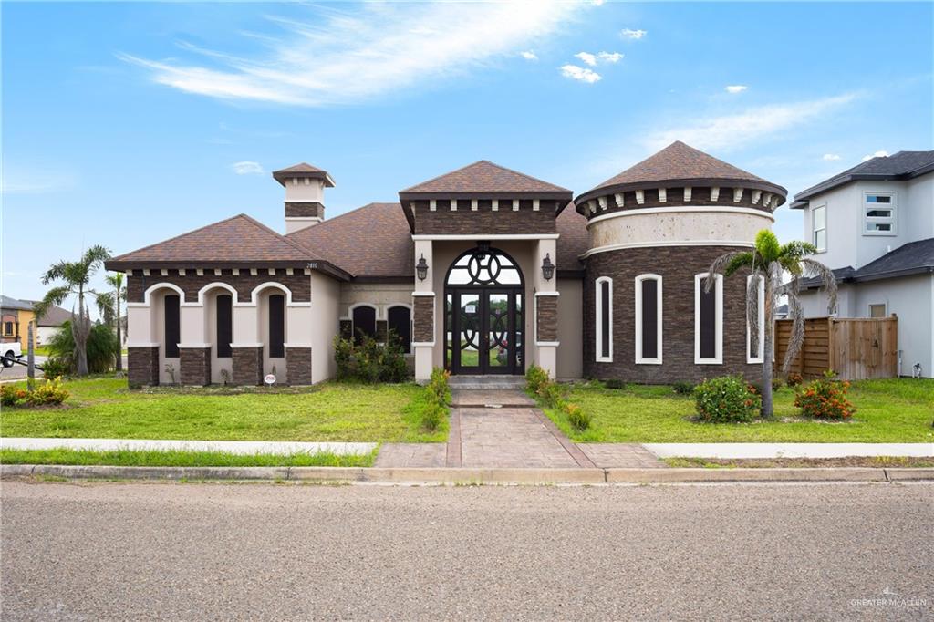 a front view of a house with a yard and garage