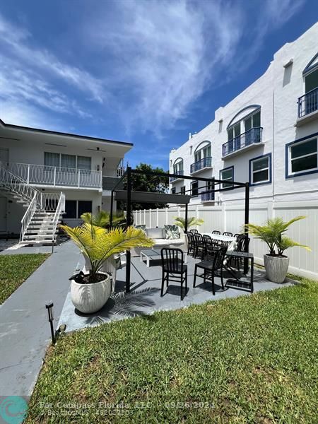 a view of a chair and tables in the patio of a house