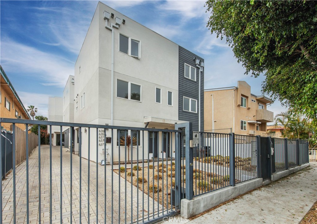 a view of a house with wooden fence