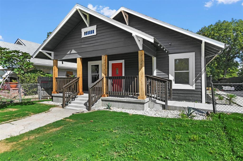 a front view of a house with garden and porch