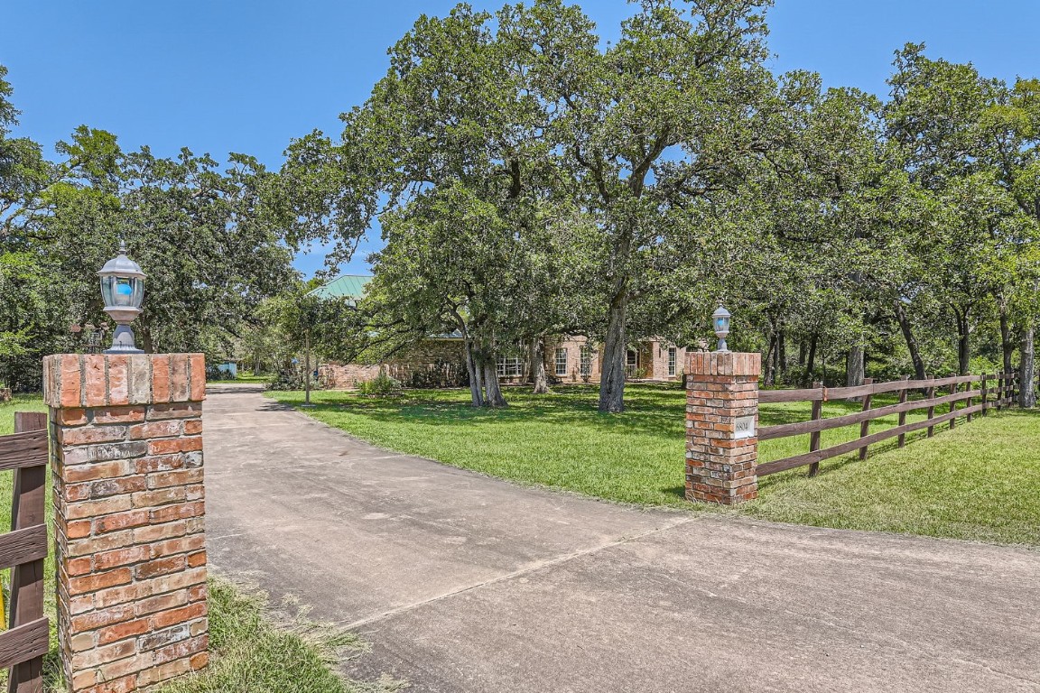 a pathway of a house with a yard