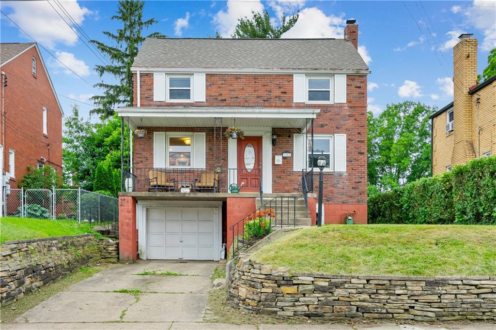 a view of a brick house with a yard