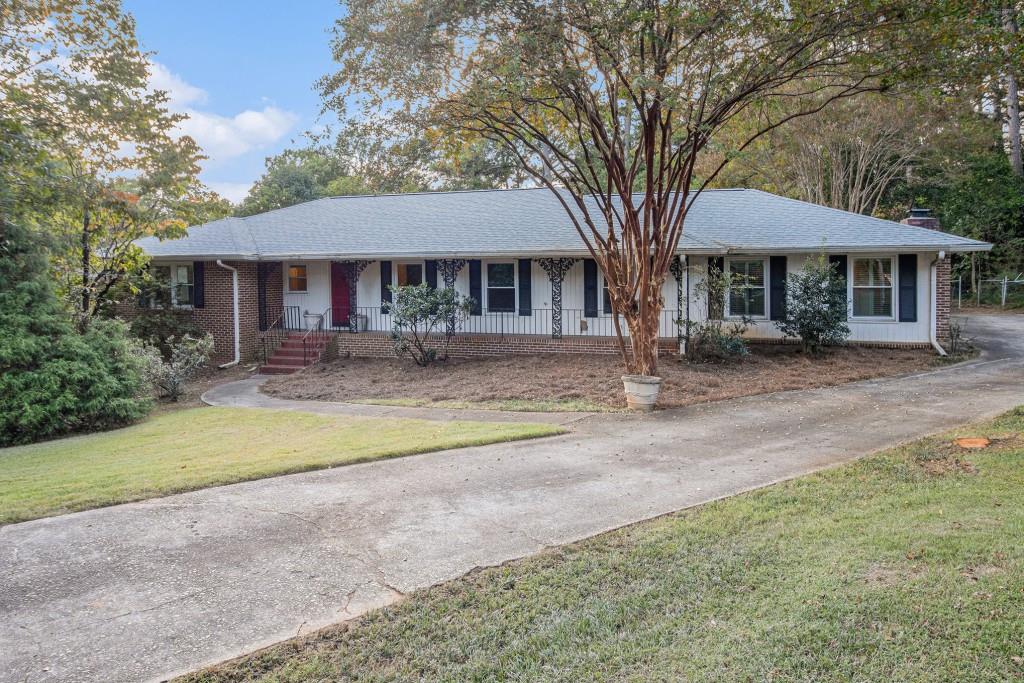 a front view of a house with yard and porch