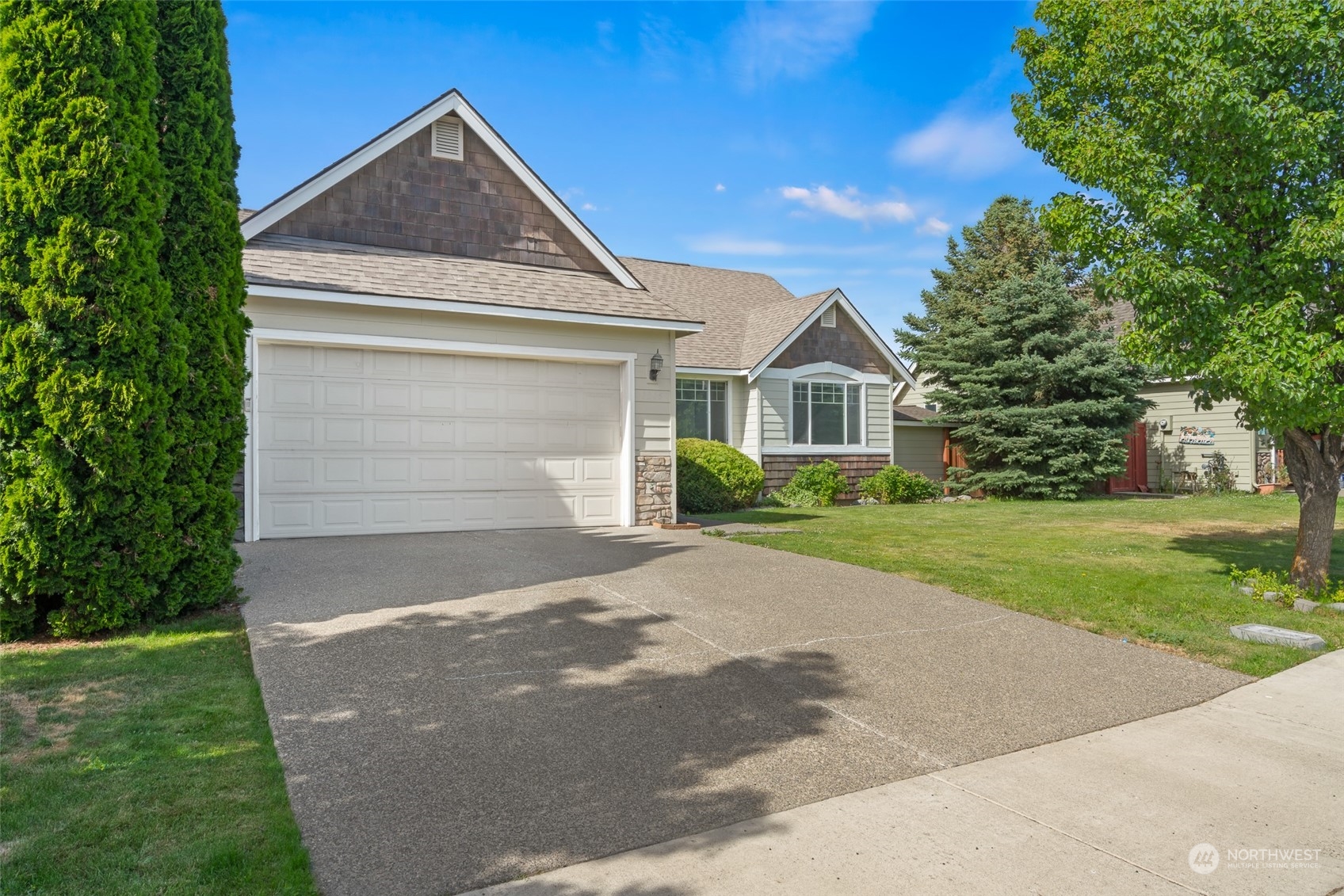 a front view of house with yard and green space