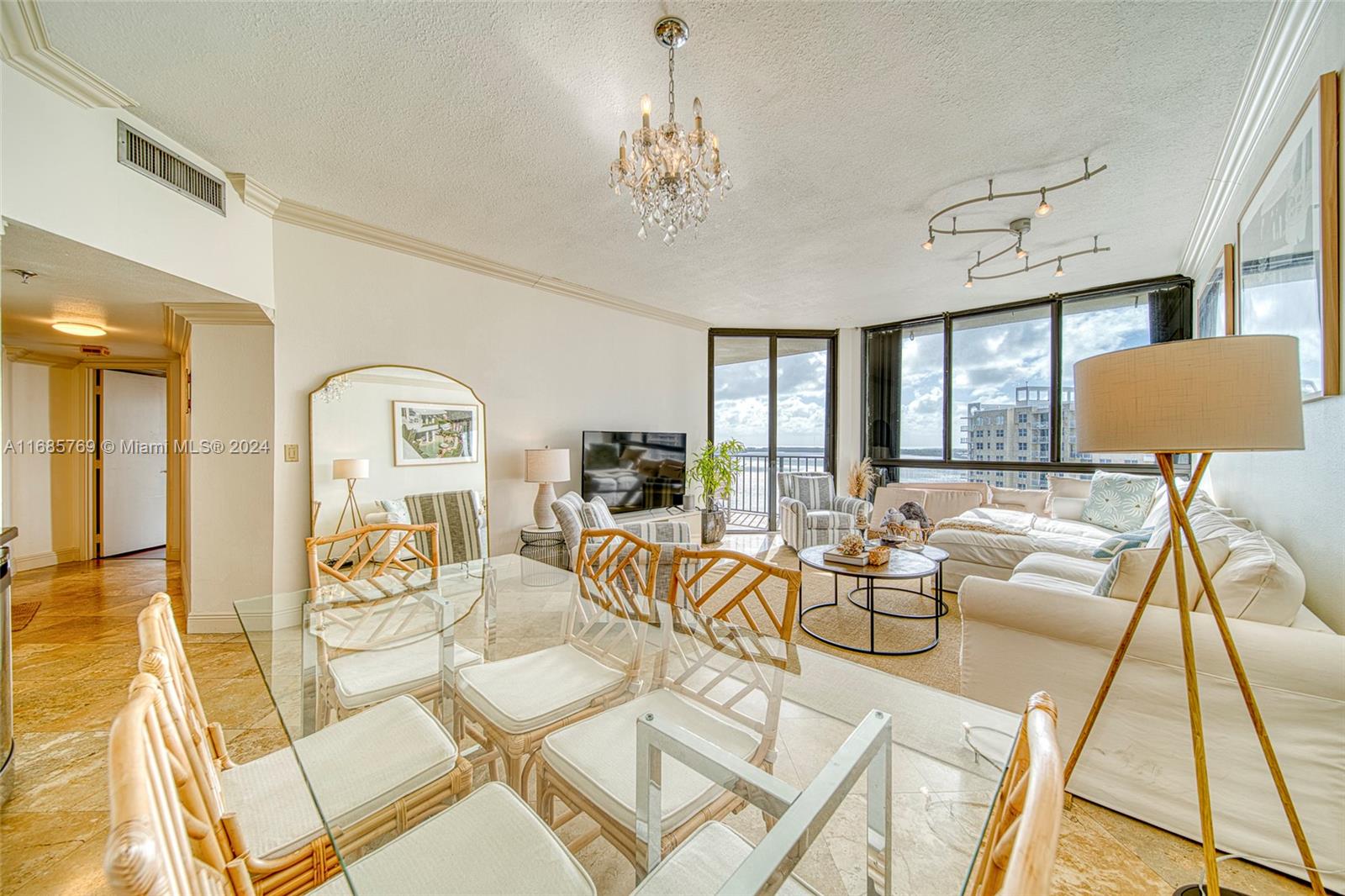 a living room with furniture and a chandelier