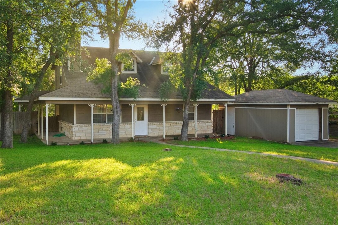 a view of a house with a yard and sitting area